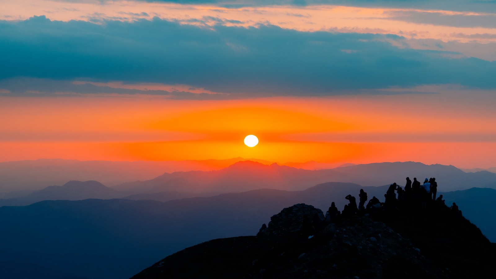 Sunset over layered mountain ridges