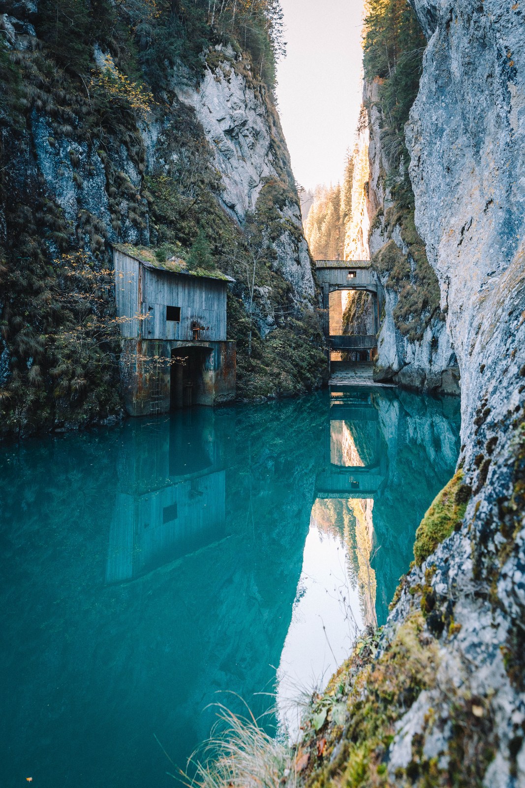 Turquoise gorge with an old wooden building